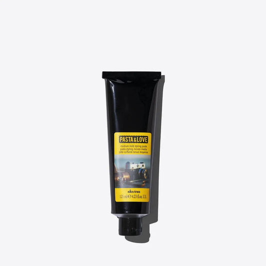 Medium-hold styling paste in a sleek black tube, ideal for flexible styles and natural finish with textured effect.