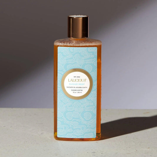 Sugar Reef Shower Oil & Bubble Bath in elegant bottle, showcasing luxurious moisturizing formula for skin cleansing.
