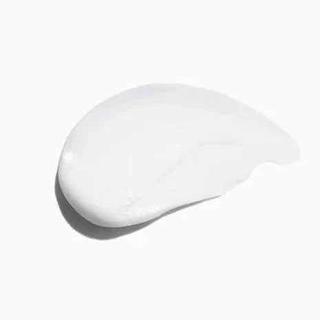 Swatch of Symbiose Fondant Apaisant Essentiel hair conditioner, white creamy texture for soothing scalp hydration.
