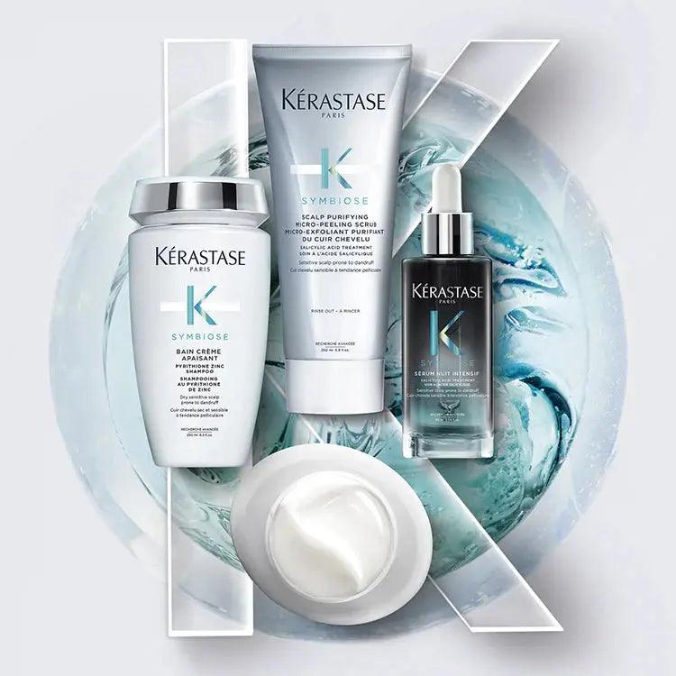 Kérastase Symbiose hair care products including serum, cream, and mask on a blue swirled background.