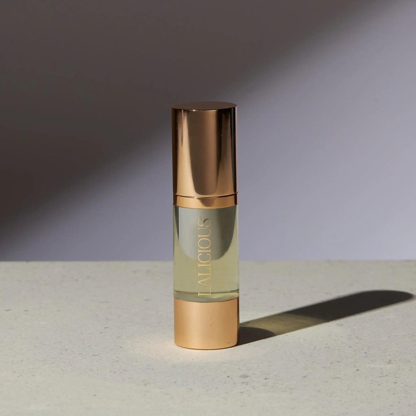 Elegant bottle of The Oil from Signature Collection, featuring luxurious gold accents and a light golden formula.