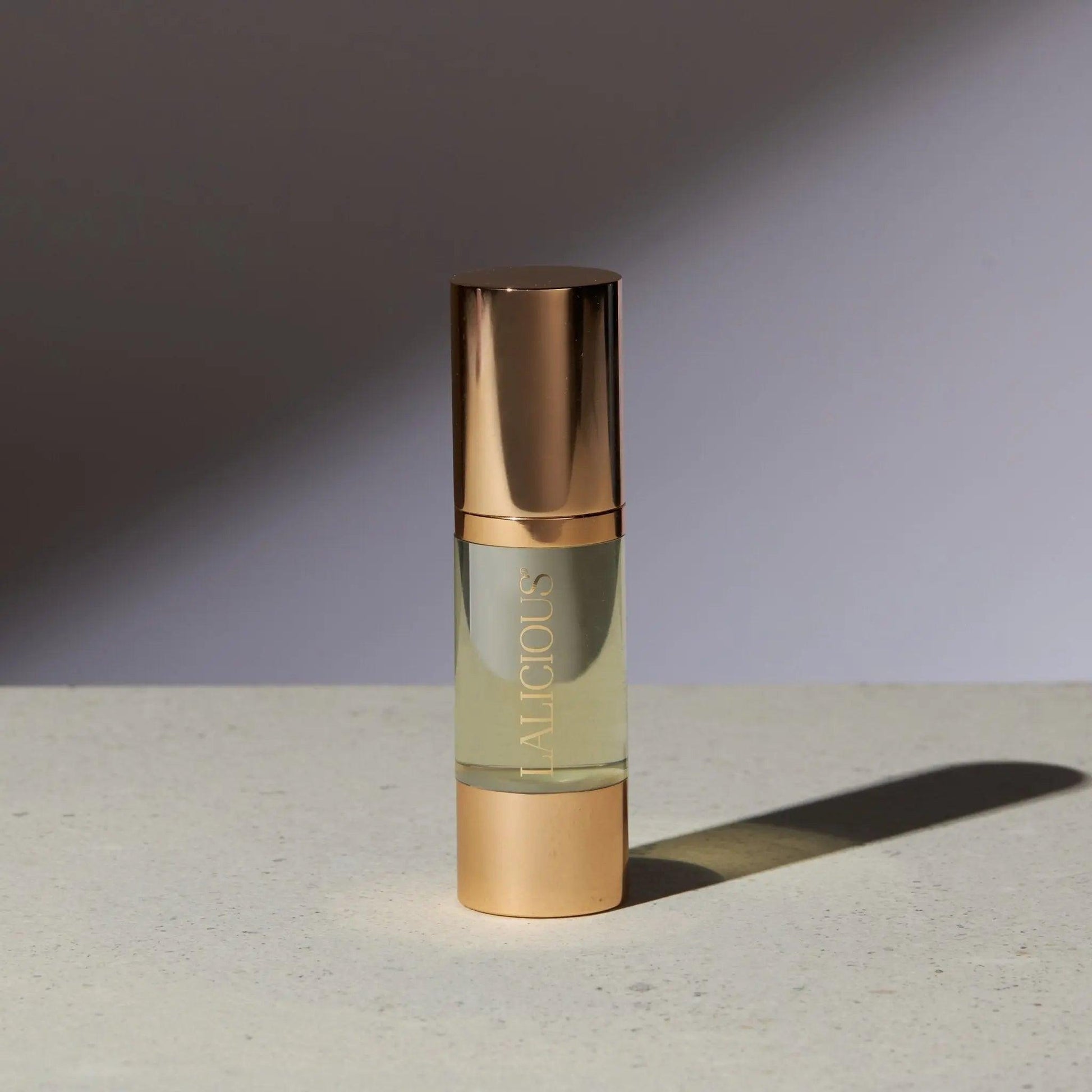 Elegant bottle of The Oil from Signature Collection, featuring luxurious gold accents and a light golden formula.