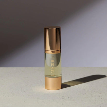 Elegant bottle of The Oil from Signature Collection, featuring luxurious gold accents and a light golden formula.