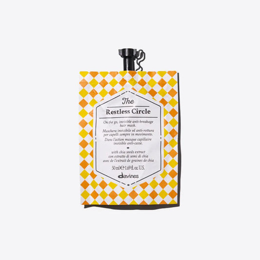 Anti-breakage hair mask called The Restless Circle in vibrant packaging, ideal for on-the-go hair care.