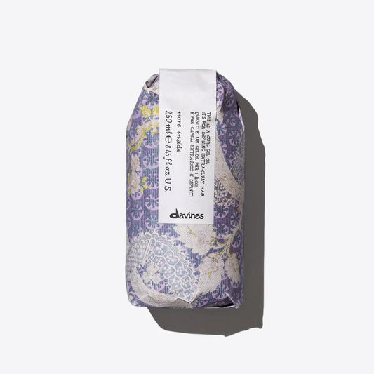 Davines curl gel oil packaging featuring elegant floral design and informative label for hydrated, defined curls.