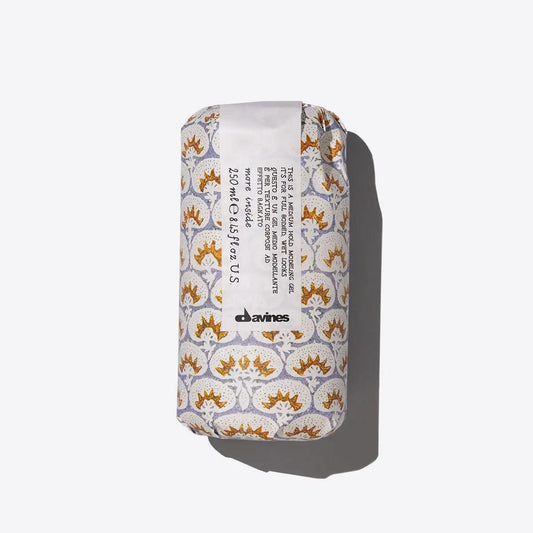 Davines hair product in printed packaging on white background