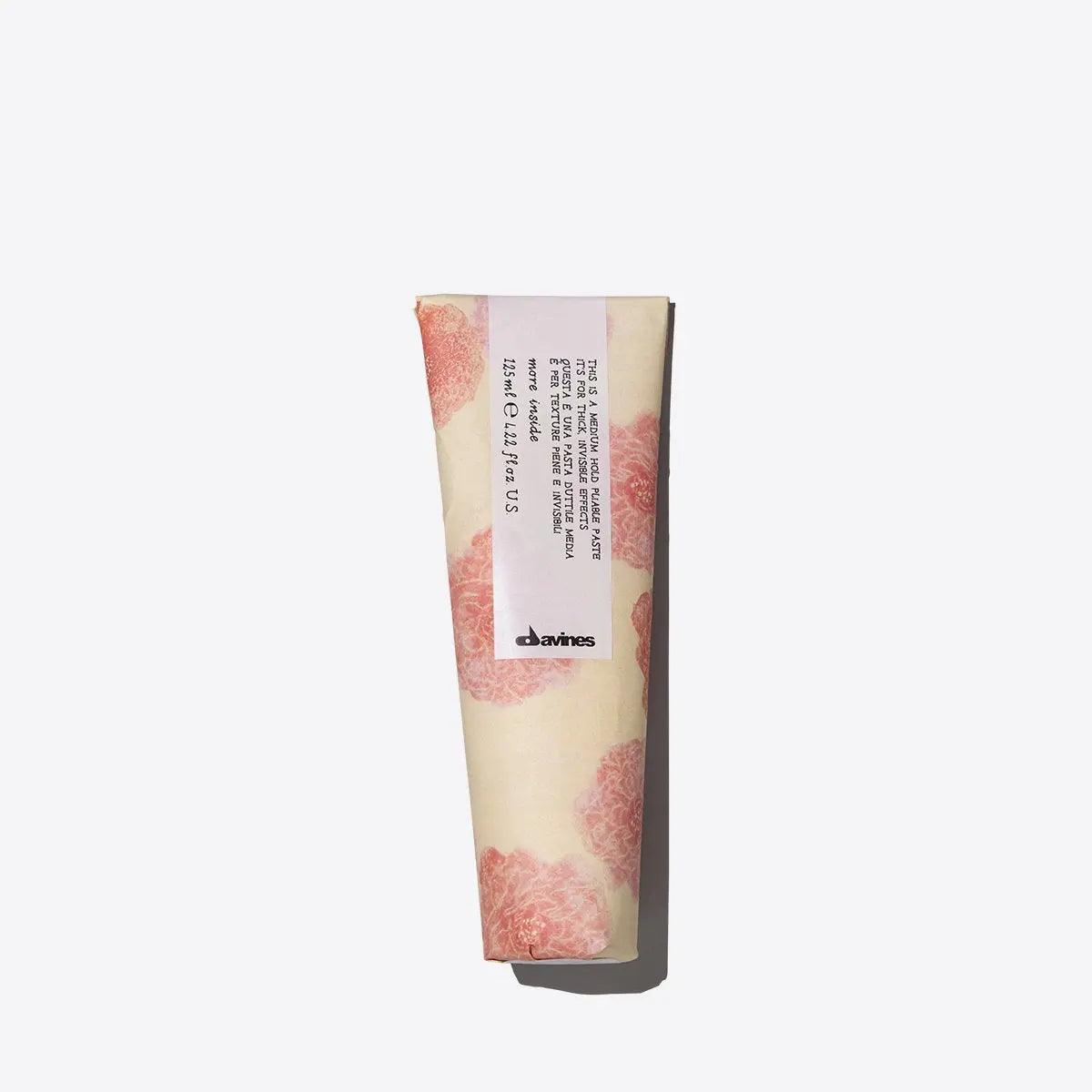 Davines hand cream tube with floral design against white background